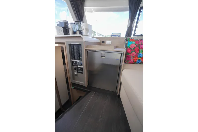 Firefly Yacht Photos Pics 2023 Fountaine Pajot Isla 40 yacht interior with modern kitchen and colorful decor.