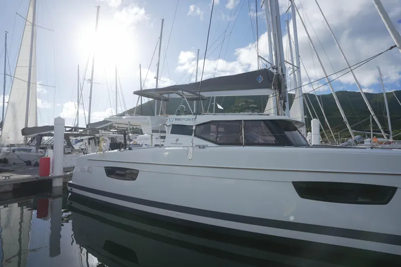 Firefly Yacht Photos Pics 2023 Fountaine Pajot Isla 40 catamaran docked in a sunny marina.
