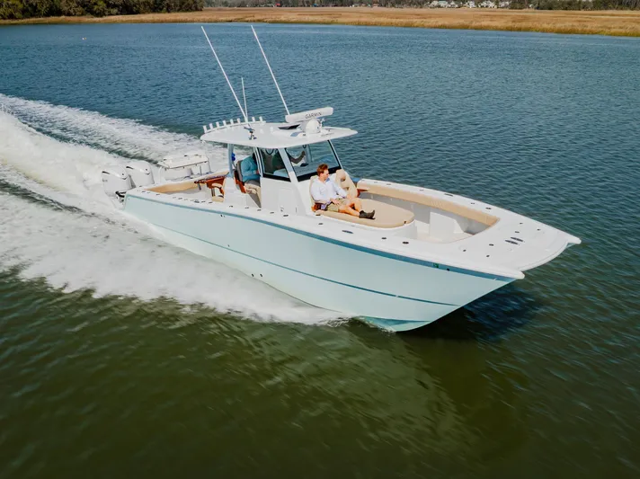  Yacht Photos Pics 2025 Freeman 38 boat cruising on calm water, featuring sleek design and spacious deck.