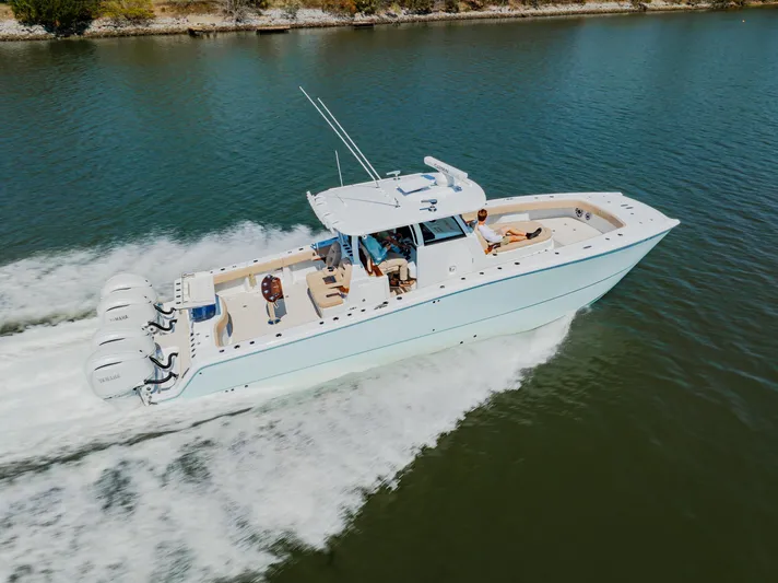  Yacht Photos Pics 2025 Freeman 38 boat cruising on a calm river with multiple outboard engines.