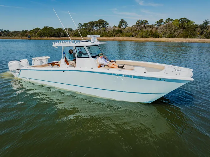  Yacht Photos Pics 2025 Freeman 38 boat cruising on a calm lake with two people onboard.