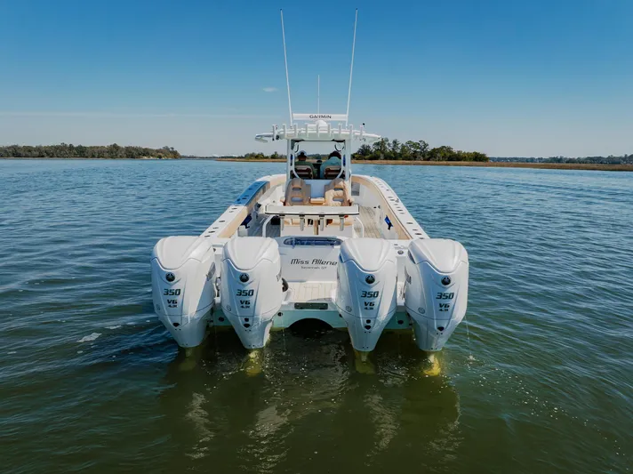  Yacht Photos Pics 2025 Freeman 38 boat with four powerful engines on a calm waterway.