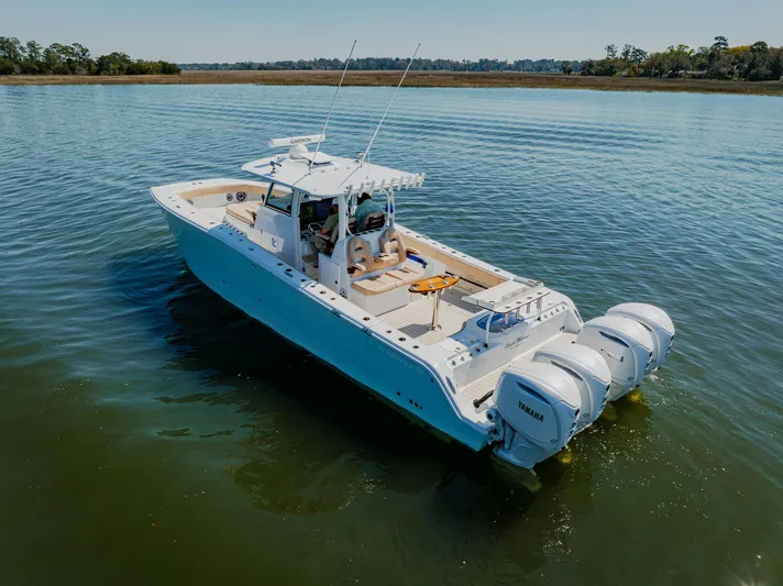  Yacht Photos Pics Freeman 38 boat, 2025 model, cruising on calm water with triple outboard engines.