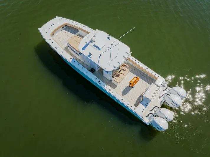 Yacht Photos Pics Aerial view of 2025 Freeman 38 boat with triple engines on calm water.