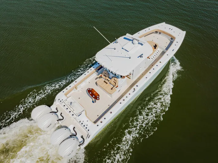  Yacht Photos Pics Aerial view of 2025 Freeman 38 boat cruising on water with triple outboard engines.