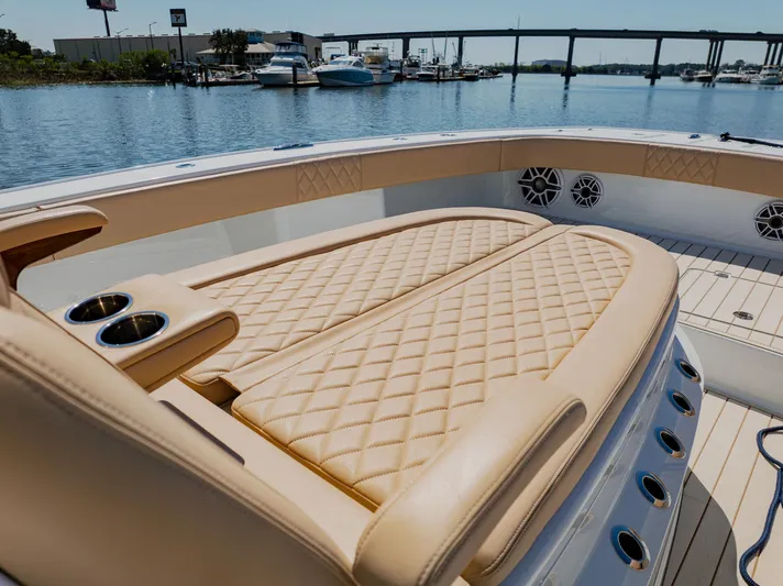  Yacht Photos Pics Luxurious seating on a 2025 Freeman 38 boat, docked by a marina.