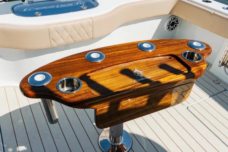  Yacht Photos Pics Luxurious Freeman 38 boat interior with polished wood table, cup holders, and modern design, 2025 model.