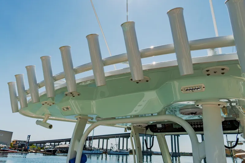  Yacht Photos Pics Freeman 38 boat's rod holders and canopy, 2025 model, docked near a bridge.