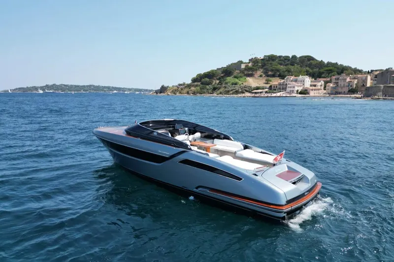  Yacht Photos Pics Luxurious 2021 Riva Dolceriva yacht cruising near scenic coastline.