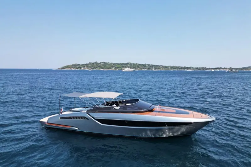  Yacht Photos Pics 2021 Riva Dolceriva luxury yacht cruising on open sea with scenic coastline backdrop.