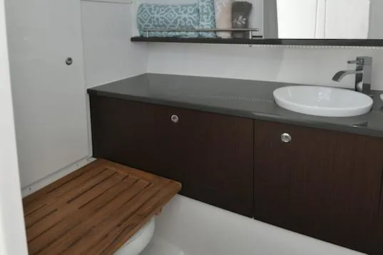  Yacht Photos Pics Manufacturer Provided Image: 2019 Everglades 340 Dual Console bathroom with modern sink and wooden accents.