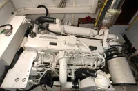 Engine room with a Cummins marine engine in a 1991 Custom 23m Epoxy Hull boat.