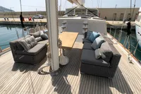 Spacious deck of 1991 Custom 23m Epoxy Hull yacht with comfortable seating and table.
