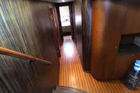 Luxurious wooden interior of a 1991 Custom 23m Epoxy Hull yacht hallway.