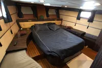 Luxurious cabin interior of 1991 Custom 23m Epoxy Hull yacht with elegant bedding.