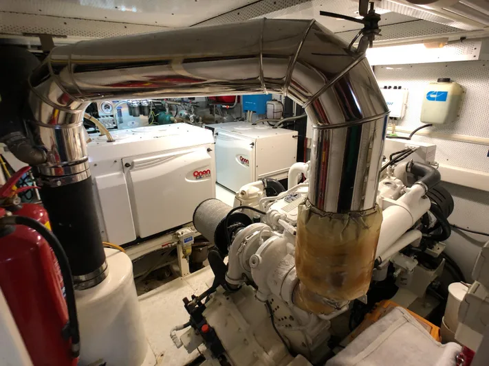 Atl 953 Yacht Photos Pics Engine room of a 1991 Custom 23m Epoxy Hull boat with visible machinery and exhaust system.