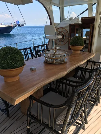 Atl 953 Yacht Photos Pics Luxurious yacht deck with wooden table, chairs, and ocean view, Custom 23m Epoxy Hull, 1991.