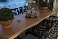 Luxurious yacht deck with wooden table, chairs, and ocean view, Custom 23m Epoxy Hull, 1991.