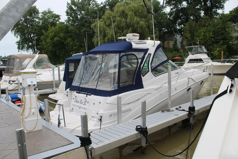  Yacht Photos Pics 2011 Four Winns V335 boat docked at marina with blue canopy.