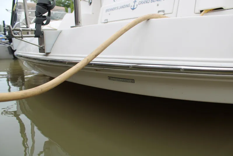  Yacht Photos Pics 2011 Four Winns V335 boat docked with hose attached, side view.
