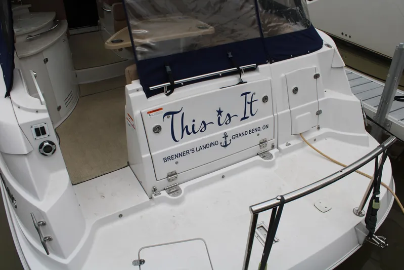  Yacht Photos Pics 2011 Four Winns V335 boat stern with "This is It" text at dock.