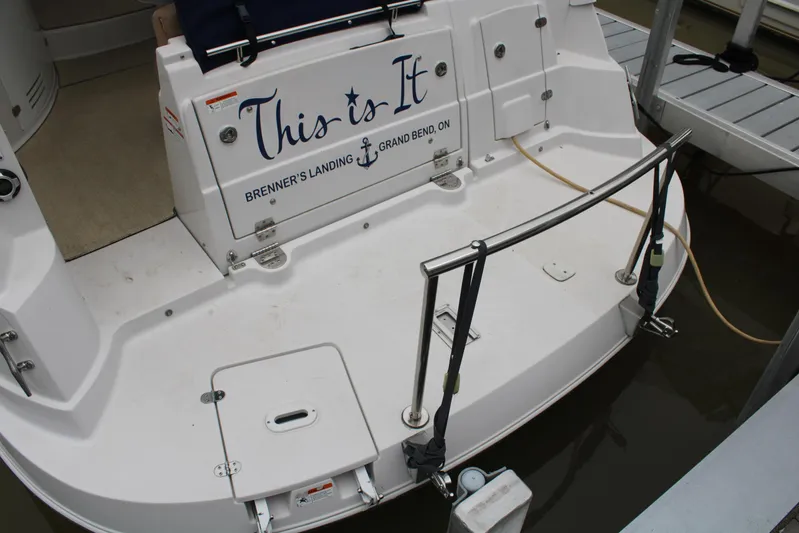  Yacht Photos Pics 2011 Four Winns V335 boat stern with "This is It" text at dock.