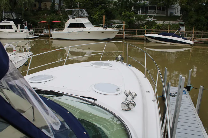  Yacht Photos Pics 2011 Four Winns V335 boat docked in a marina with other vessels nearby.