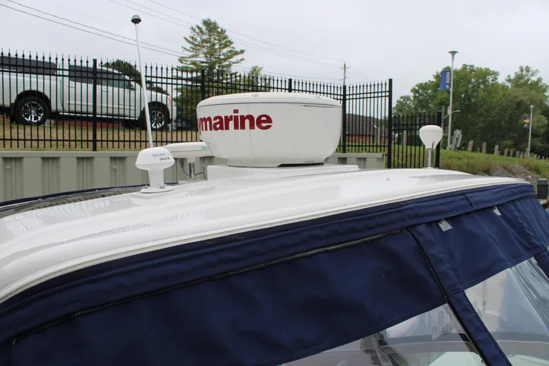  Yacht Photos Pics 2011 Four Winns V335 boat with radar equipment and blue canopy.