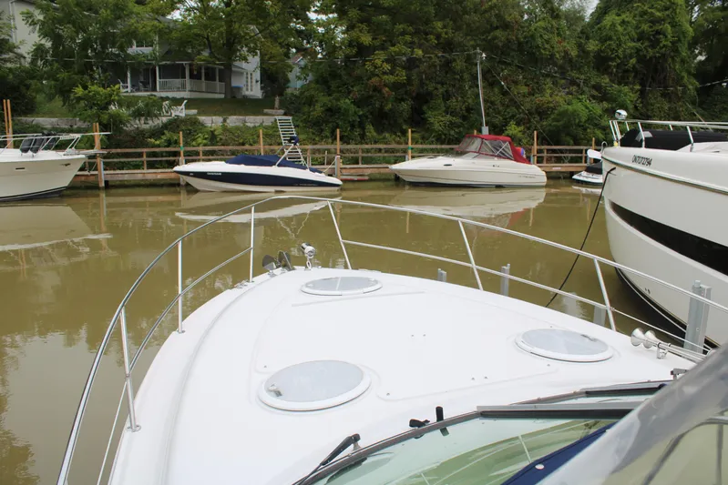  Yacht Photos Pics 2011 Four Winns V335 boat docked in a marina with other boats nearby.