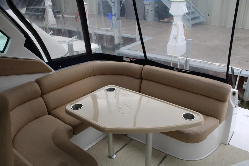  Yacht Photos Pics Interior of 2011 Four Winns V335 boat with beige seating and table.