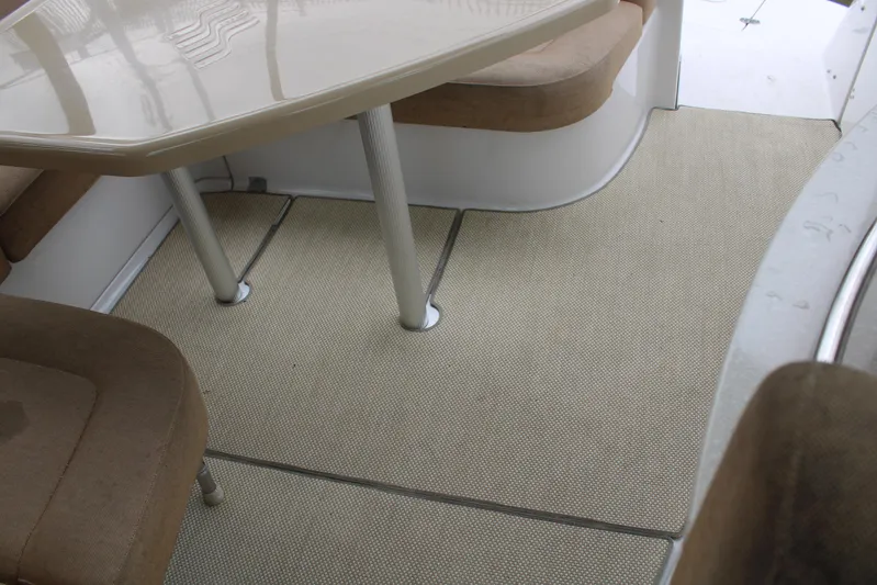  Yacht Photos Pics 2011 Four Winns V335 interior with beige seating and carpeted flooring.