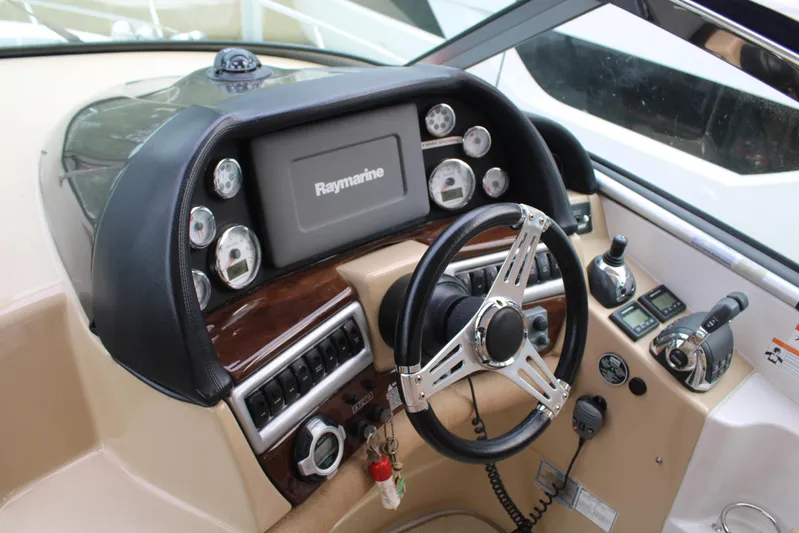  Yacht Photos Pics 2011 Four Winns V335 boat dashboard with Raymarine navigation system and steering wheel.