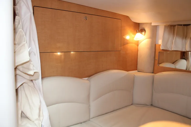  Yacht Photos Pics Interior cabin of 2011 Four Winns V335 boat with cozy seating and warm lighting.
