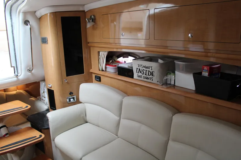  Yacht Photos Pics Interior of 2011 Four Winns V335 yacht with white leather seating and wooden cabinetry.