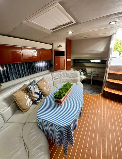  Yacht Photos Pics Interior of a 2006 Formula 40pc yacht with elegant seating and striped tablecloth.