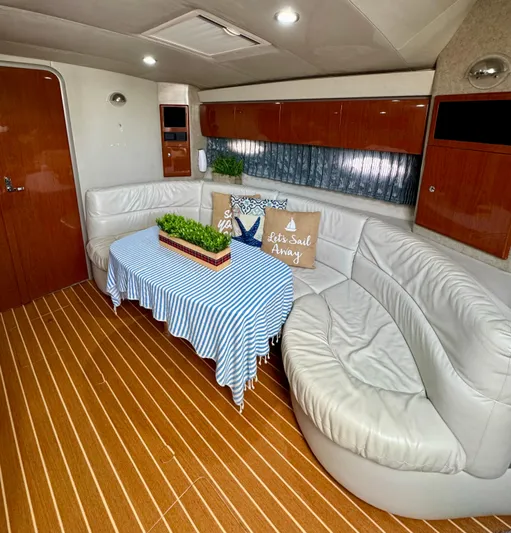  Yacht Photos Pics Luxurious 2006 Formula 40pc yacht interior with white leather seating and striped tablecloth.