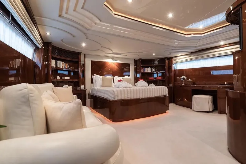 Let It Be Yacht Photos Pics Luxurious Tecnomarine Custom 1998 yacht interior with elegant wood finishes and plush bedding.