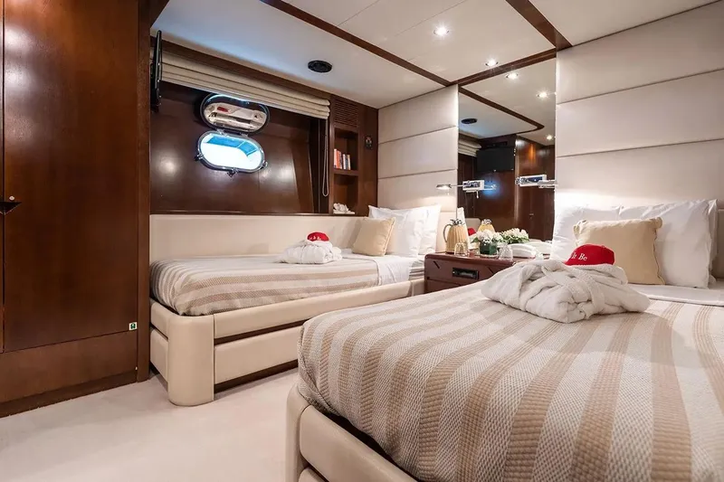 Let It Be Yacht Photos Pics Luxurious 1998 Tecnomarine Custom yacht bedroom with twin beds and elegant decor.
