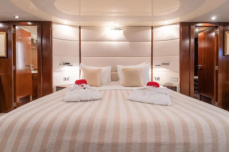 Let It Be Yacht Photos Pics Luxurious Tecnomarine Custom 1998 yacht bedroom with elegant decor and plush bedding.