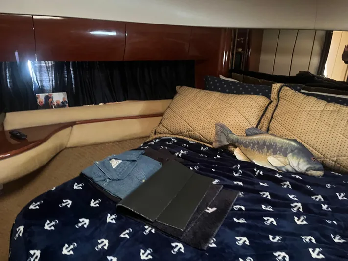 C Glass Yacht Photos Pics Luxurious cabin interior of 2000 Princess 65 M/Y yacht with nautical-themed bedding.