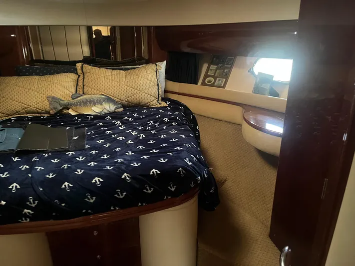 C Glass Yacht Photos Pics Luxurious cabin interior of 2000 Princess 65 M/Y yacht with nautical-themed bedding.