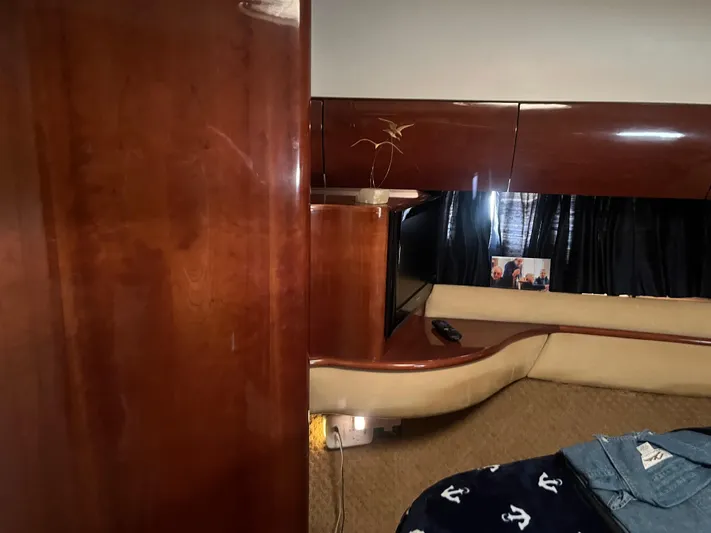 C Glass Yacht Photos Pics Interior of 2000 Princess 65 M/Y yacht with wood paneling and cozy seating area.