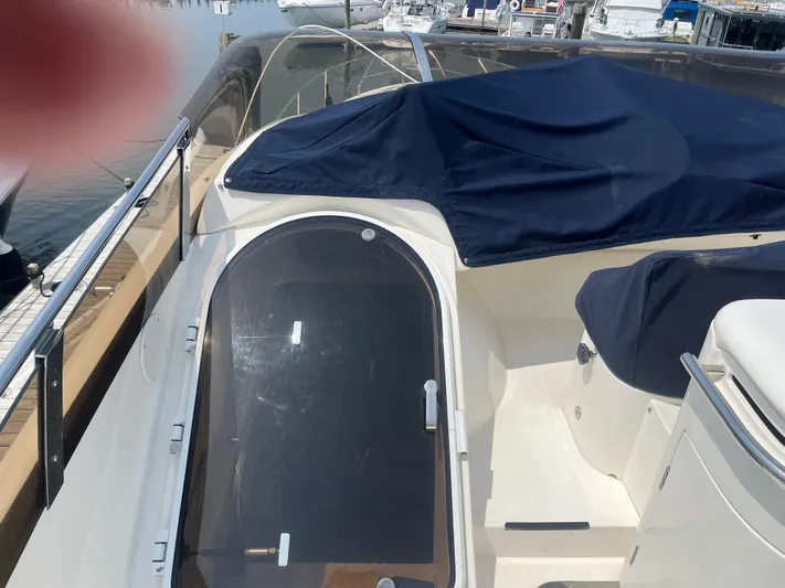 C Glass Yacht Photos Pics Princess 65 M/Y 2000 yacht deck with covered seating and glass door.