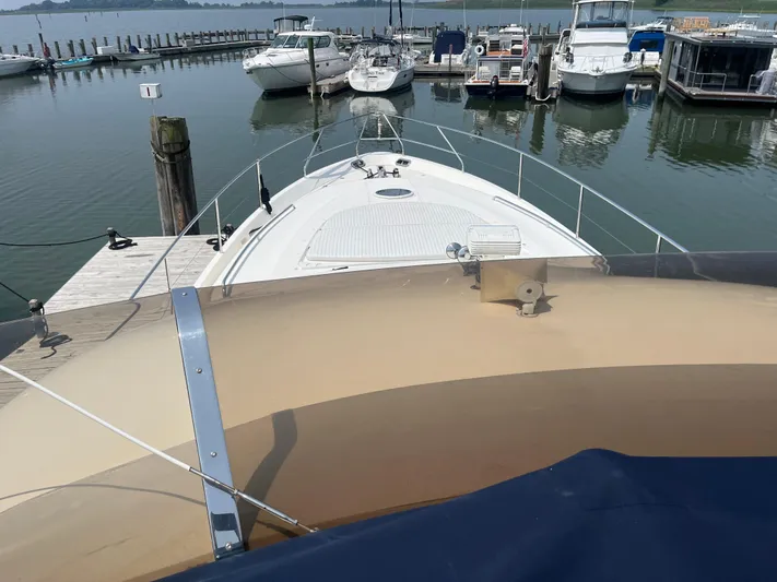 C Glass Yacht Photos Pics Bow view of a 2000 Princess 65 M/Y yacht docked at a marina.