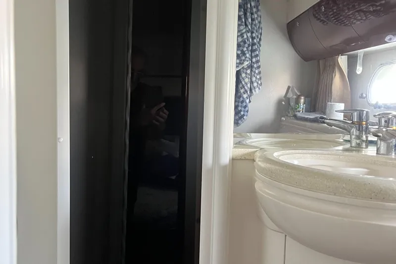 C Glass Yacht Photos Pics Bathroom interior of 2000 Princess 65 M/Y yacht, featuring sink and mirror.