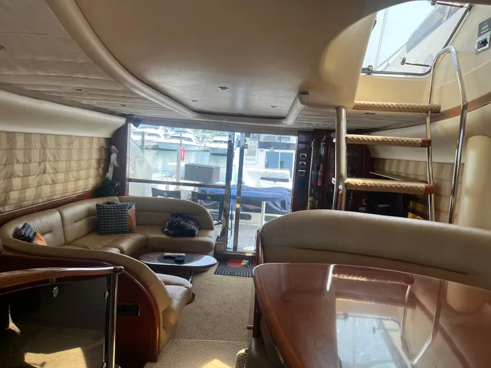 C Glass Yacht Photos Pics Luxurious interior of a 2000 Princess 65 M/Y yacht with elegant seating and staircase.