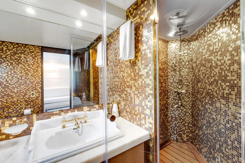 Ginger Yacht Photos Pics Luxurious bathroom with mosaic tiles and elegant fixtures on a 2006 Pershing 115 yacht.