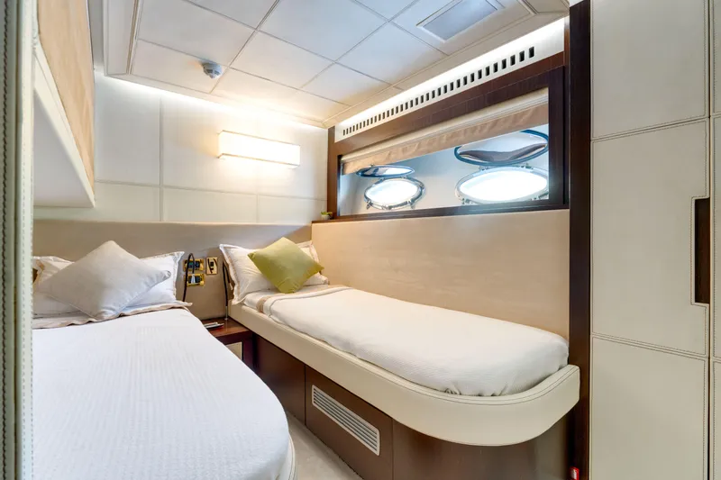 Ginger Yacht Photos Pics Luxurious cabin interior of 2006 Pershing 115 yacht with twin beds and porthole windows.