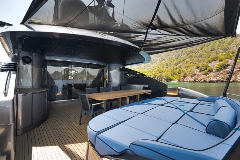 Ginger Yacht Photos Pics Luxurious 2006 Pershing 115 yacht deck with seating, dining area, and scenic water view.