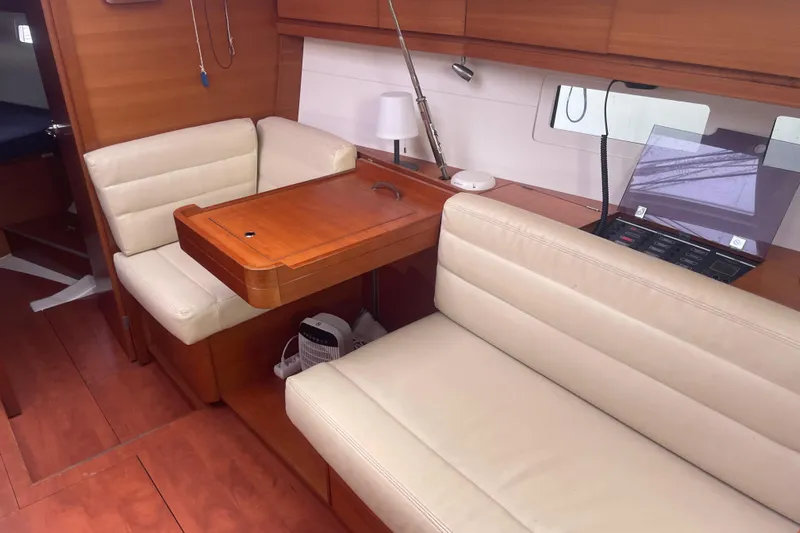  Yacht Photos Pics Interior of 2015 Dufour 41.2 GL yacht with beige seating and wooden table.
